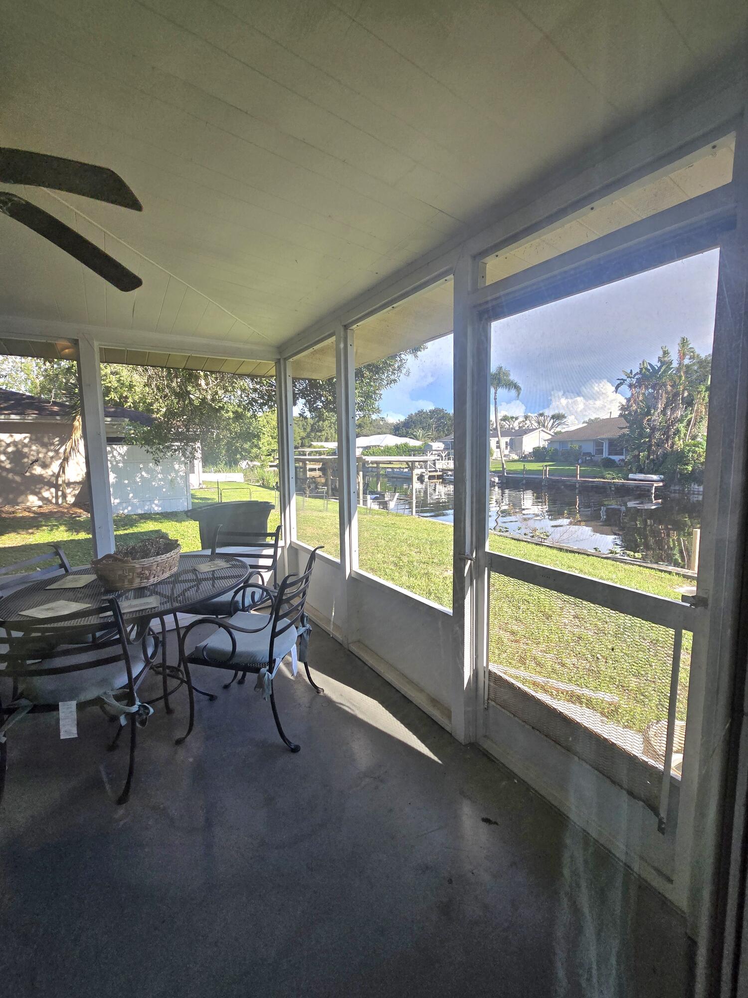 2612 Southeast 29th Street Okeechobee, FL 34974 - Photo 37 of 46 a view of a work space with furniture and floor to ceiling window