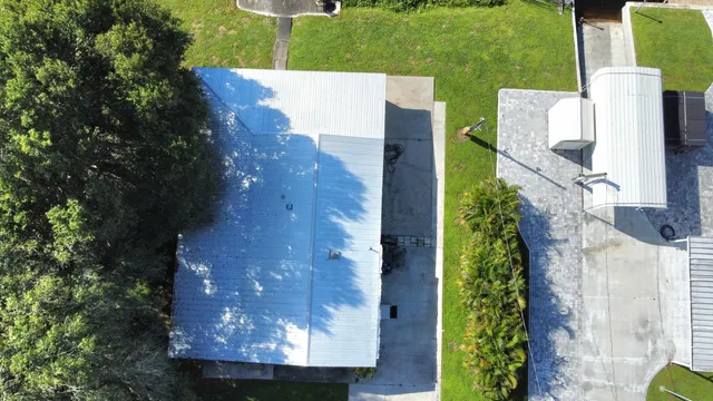 an aerial view of a house with a yard