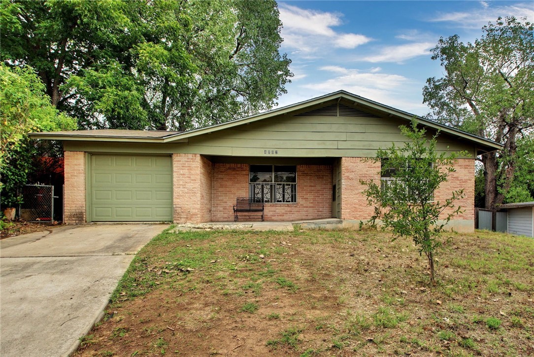 a front view of house with yard and trees