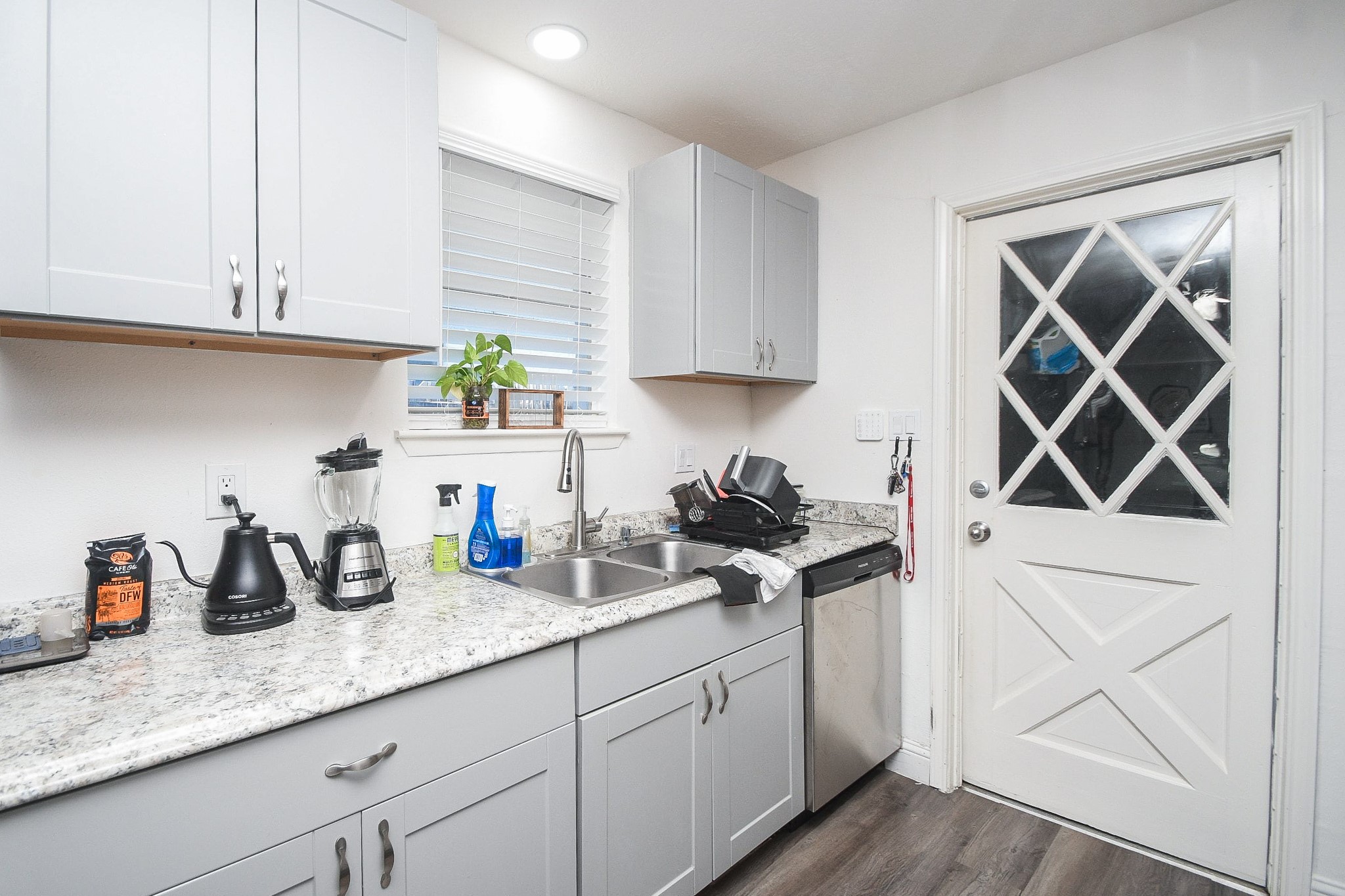 11443 Newbrook Drive Houston, TX 77072 - Photo 12 of 31 a kitchen with granite countertop white cabinets and white appliances