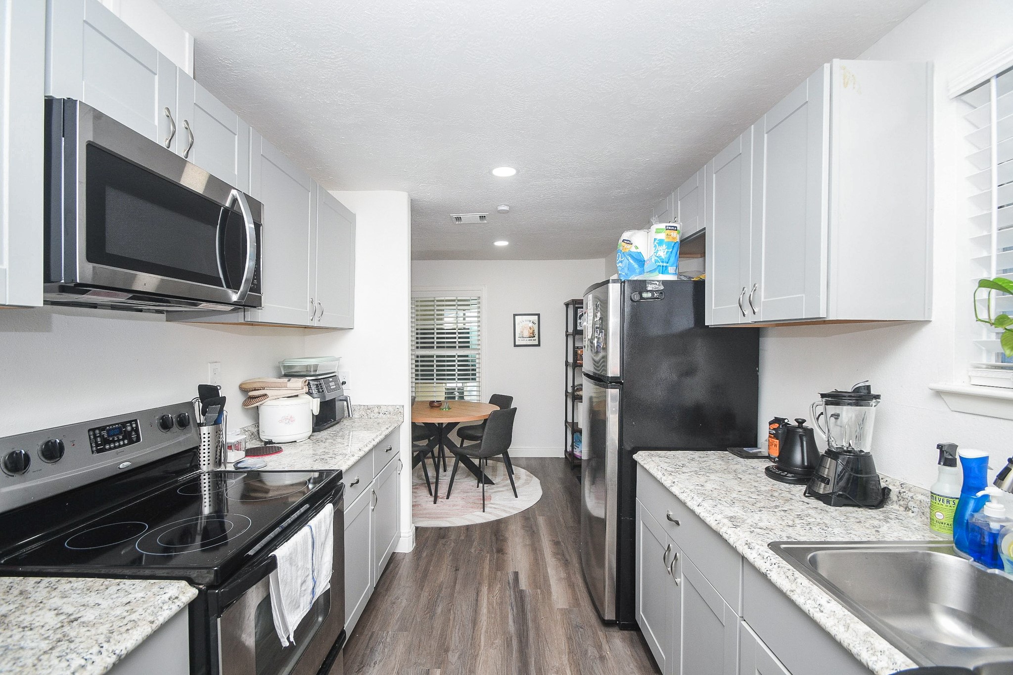 11443 Newbrook Drive Houston, TX 77072 - Photo 13 of 31 a kitchen with granite countertop kitchen island stainless steel appliances a stove sink microwave and cabinets