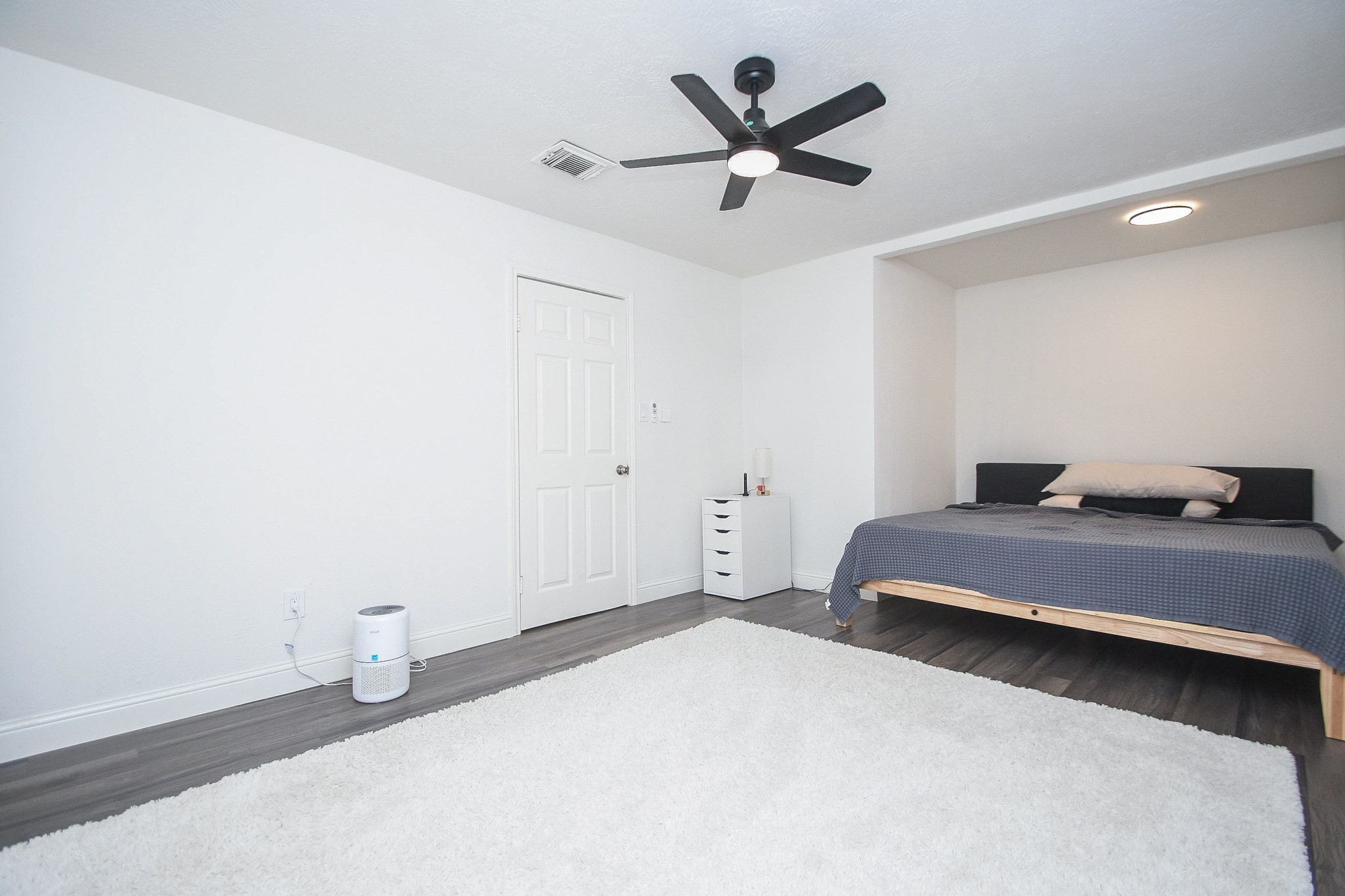 11443 Newbrook Drive Houston, TX 77072 - Photo 16 of 31 a bedroom with a bed and a chandelier