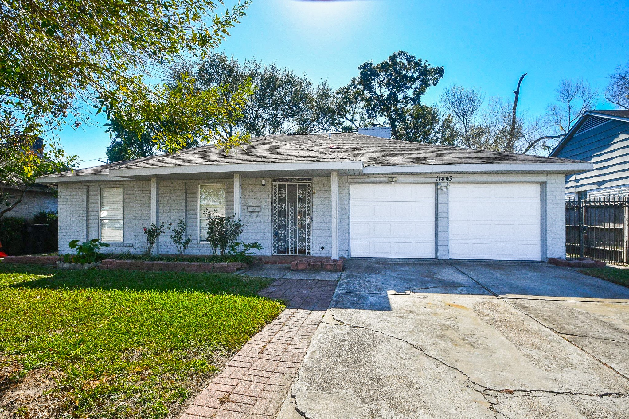 11443 Newbrook Drive Houston, TX 77072 - Photo 2 of 31 a front view of a house with a yard and garage