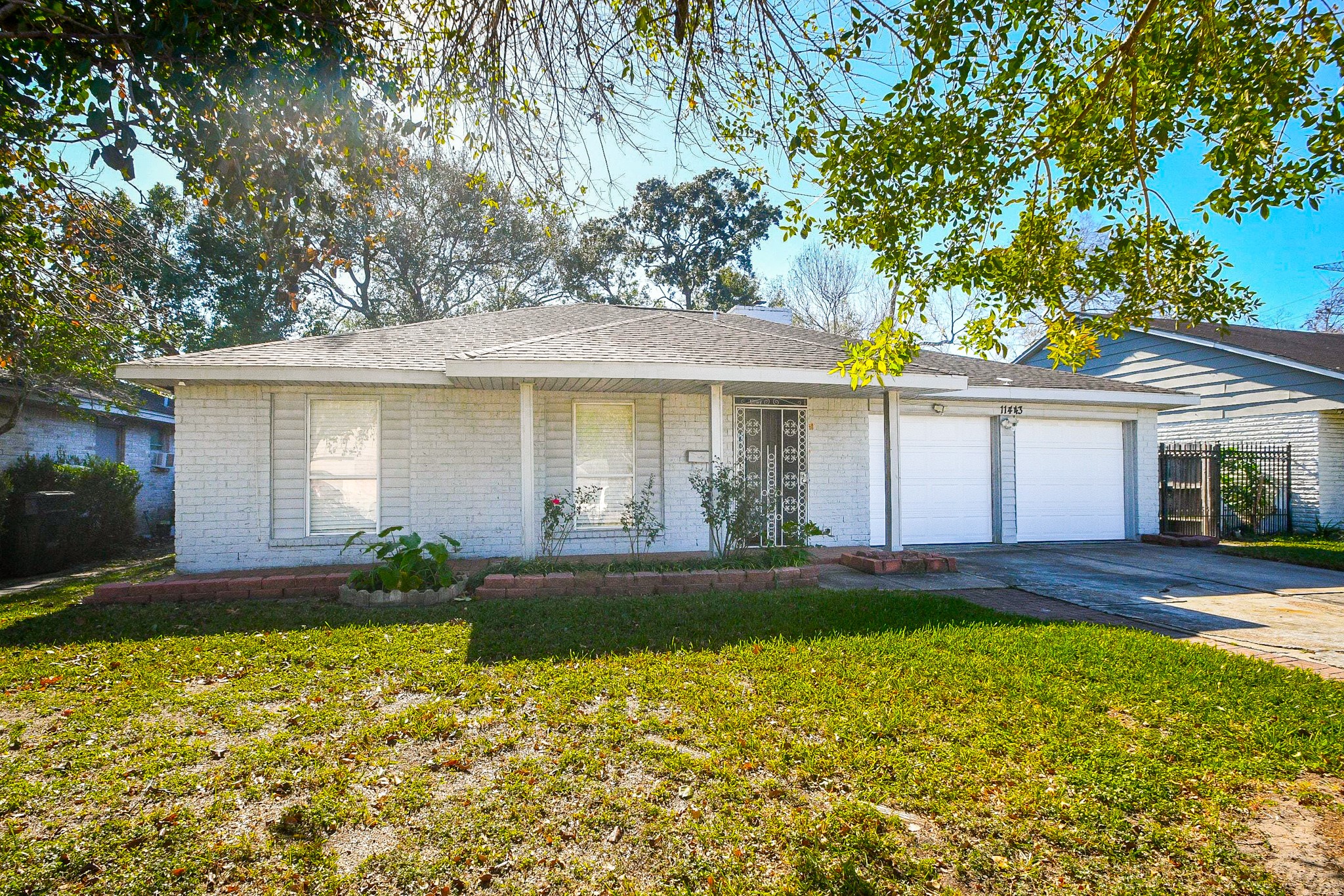 11443 Newbrook Drive Houston, TX 77072 - Photo 3 of 31 a front view of a house with a yard and porch