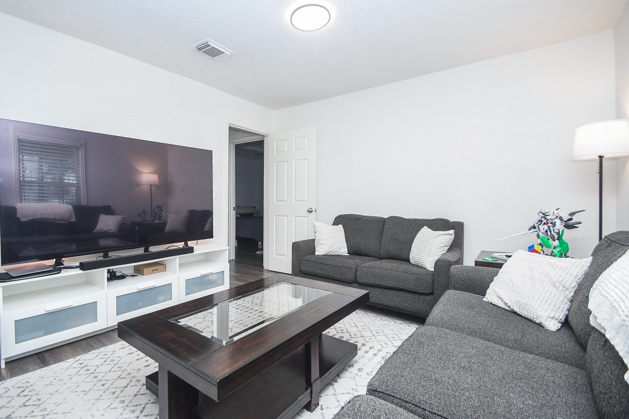 11443 Newbrook Drive Houston, TX 77072 - Photo 9 of 31 a living room with furniture and a flat screen tv