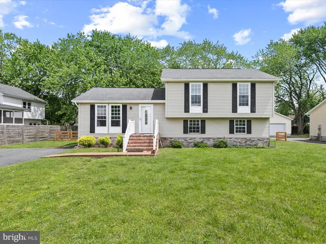 a front view of a house with a yard porch and furniture