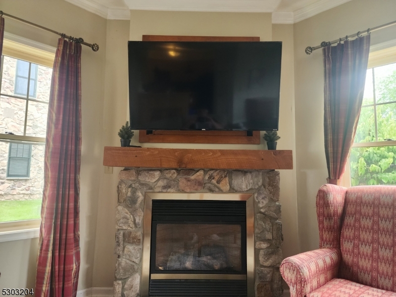 7 Maple Crescent, Unit 11 Vernon, NJ 07462 - Photo 11 of 42 a living room with a fireplace and a flat screen tv