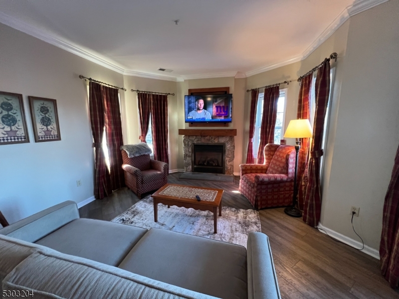 7 Maple Crescent, Unit 11 Vernon, NJ 07462 - Photo 12 of 42 a living room with furniture fireplace and a flat screen tv