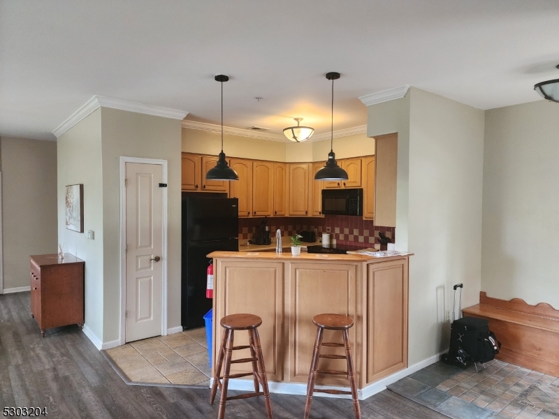 7 Maple Crescent, Unit 11 Vernon, NJ 07462 - Photo 19 of 42 a kitchen island with a table and chairs in it