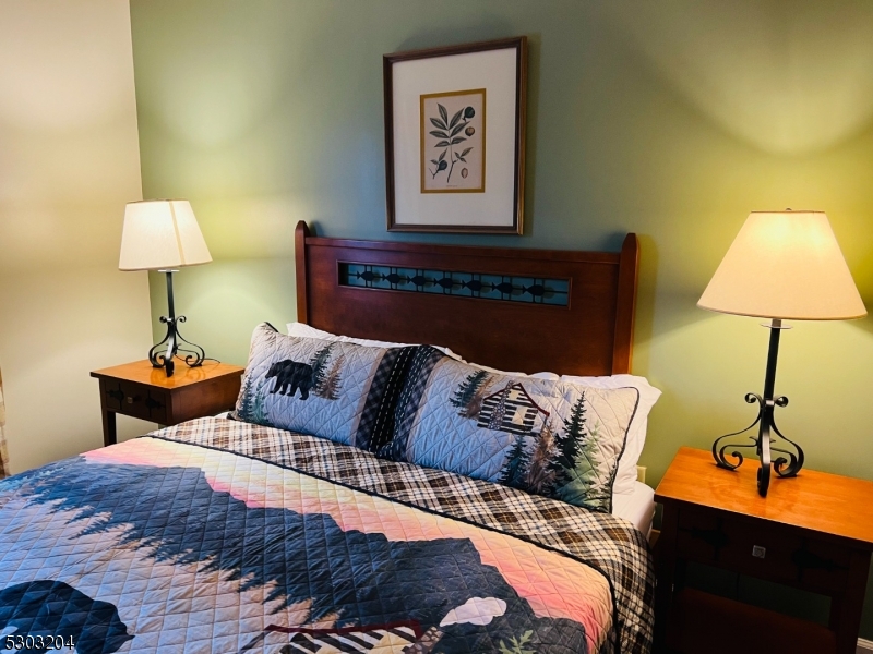 7 Maple Crescent, Unit 11 Vernon, NJ 07462 - Photo 23 of 42 a bedroom with a bed and a lamp