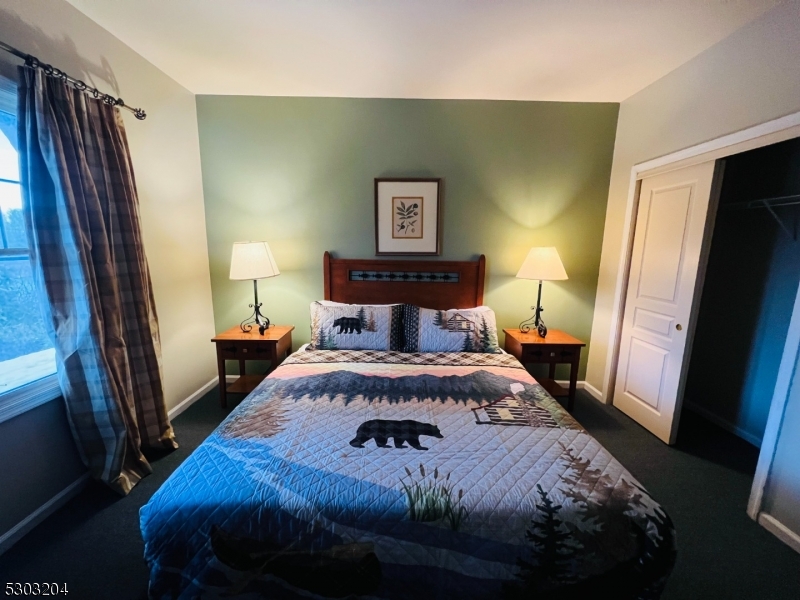 7 Maple Crescent, Unit 11 Vernon, NJ 07462 - Photo 25 of 42 a bedroom with a bed and a mirror