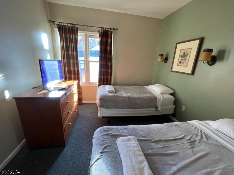 7 Maple Crescent, Unit 11 Vernon, NJ 07462 - Photo 32 of 42 a bedroom with a bed and a window
