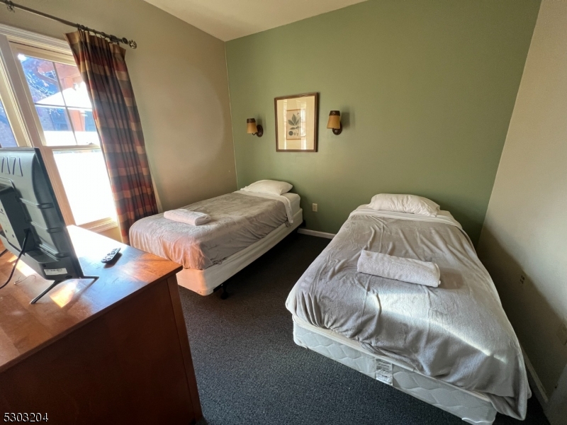 7 Maple Crescent, Unit 11 Vernon, NJ 07462 - Photo 33 of 42 a bedroom with a bed and a window