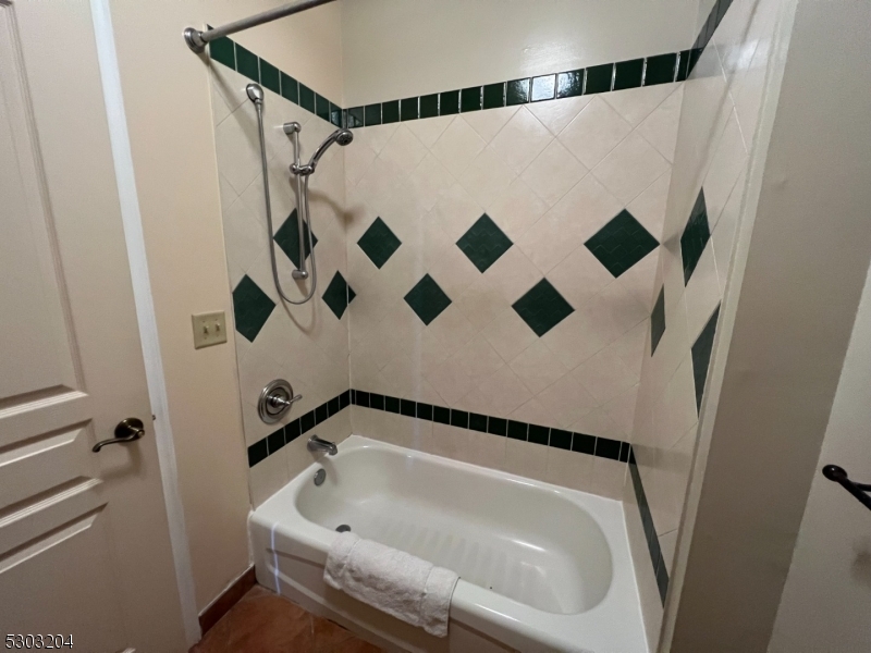 7 Maple Crescent, Unit 11 Vernon, NJ 07462 - Photo 36 of 42 a bathroom with a bathtub and shower