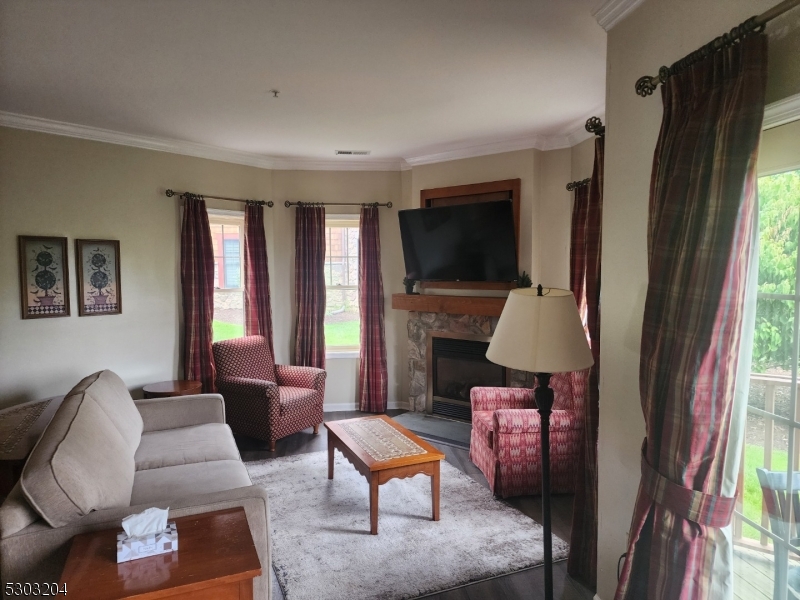 7 Maple Crescent, Unit 11 Vernon, NJ 07462 - Photo 6 of 42 a living room with furniture fireplace and a flat screen tv
