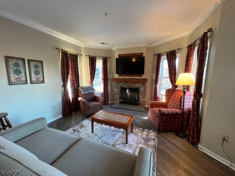 7 Maple Crescent, Unit 11 Vernon, NJ 07462 - Photo 9 of 42 a living room with furniture a large window and a fireplace