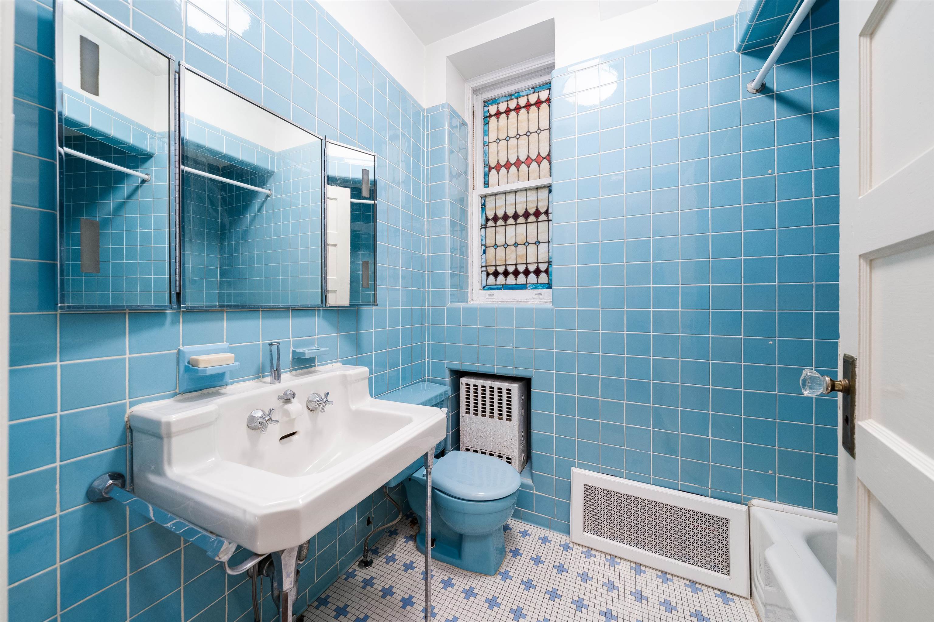 901 Castle Point Terrace Hoboken, NJ 07030 - Photo 20 of 40 a bathroom with a sink a toilet and a mirror