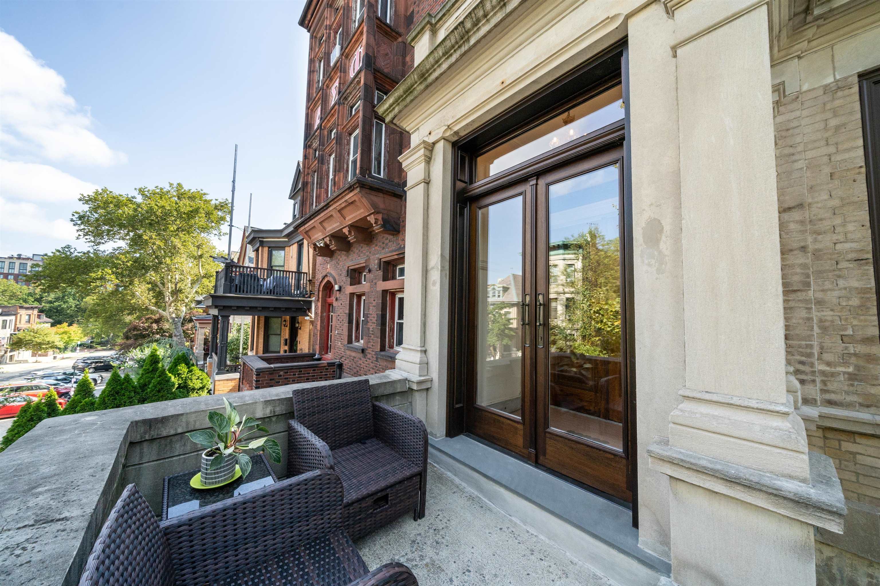 901 Castle Point Terrace Hoboken, NJ 07030 - Photo 38 of 40 a view of a patio with couches and a potted plant on the side of a building