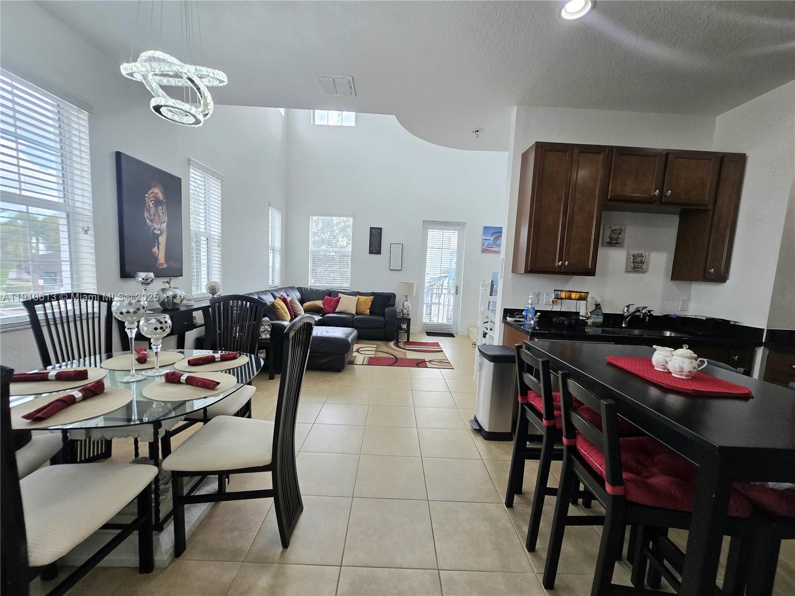 11938 Southwest 26th Court Miramar, FL 33025 - Photo 19 of 62 a view of a dining room with furniture and a chandelier