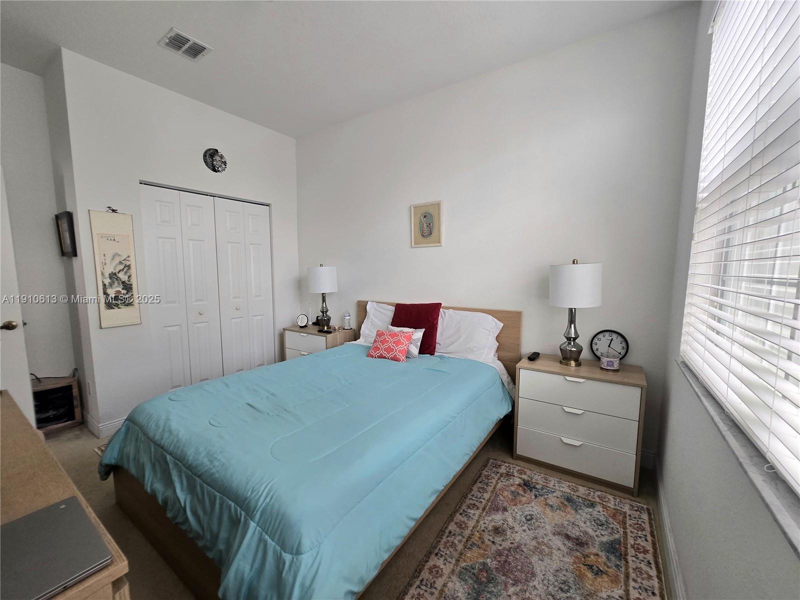 11938 Southwest 26th Court Miramar, FL 33025 - Photo 21 of 62 a bedroom with a bed and wooden floor