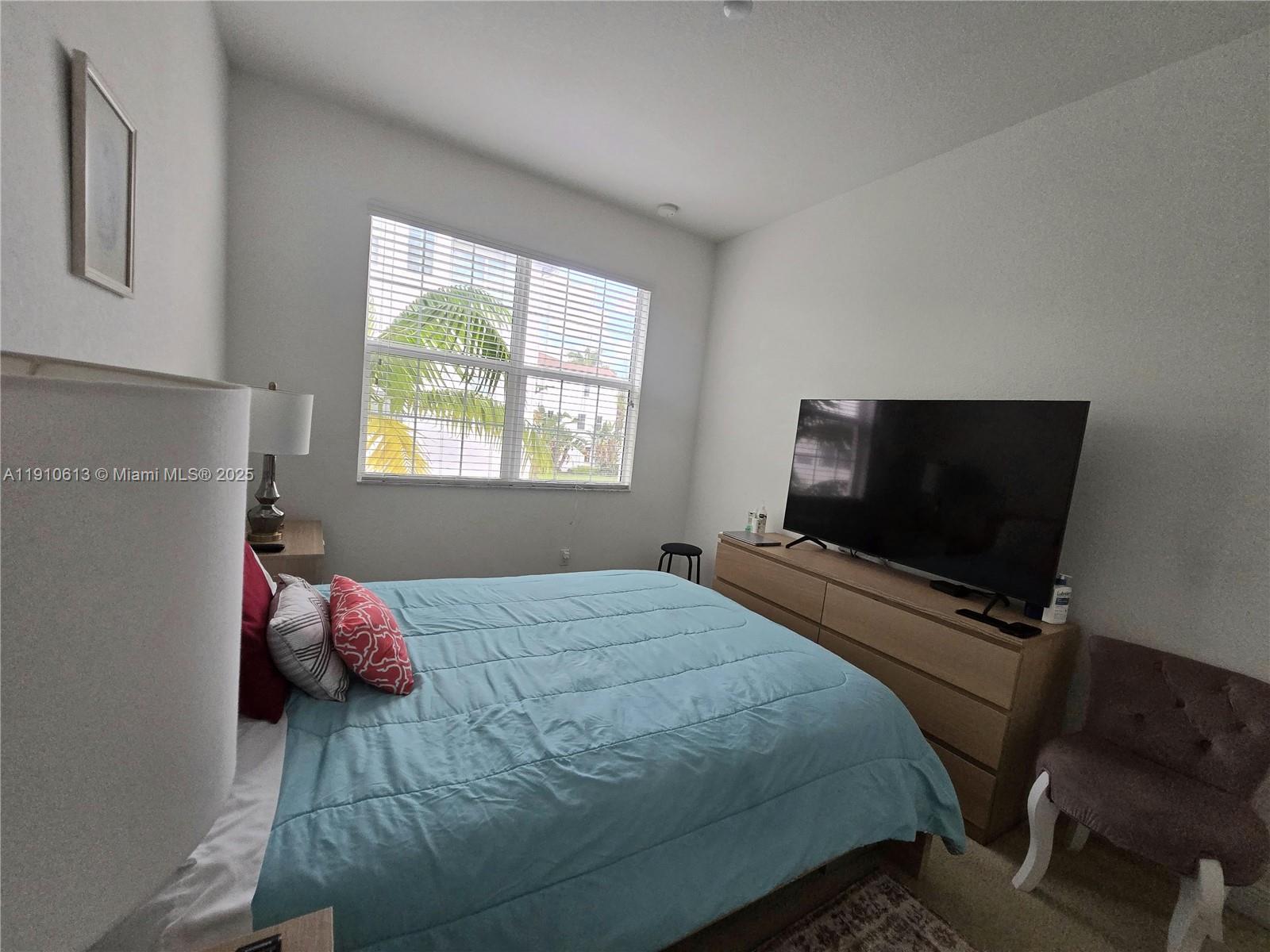 11938 Southwest 26th Court Miramar, FL 33025 - Photo 23 of 62 a bedroom with a bed and a flat screen tv