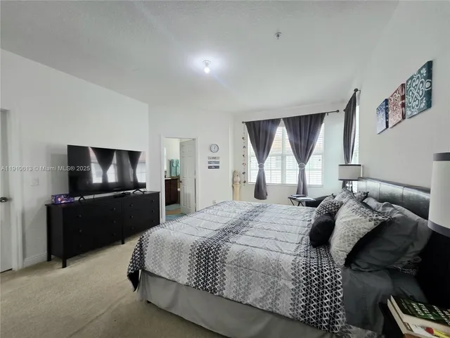 a bedroom with a bed and a tv