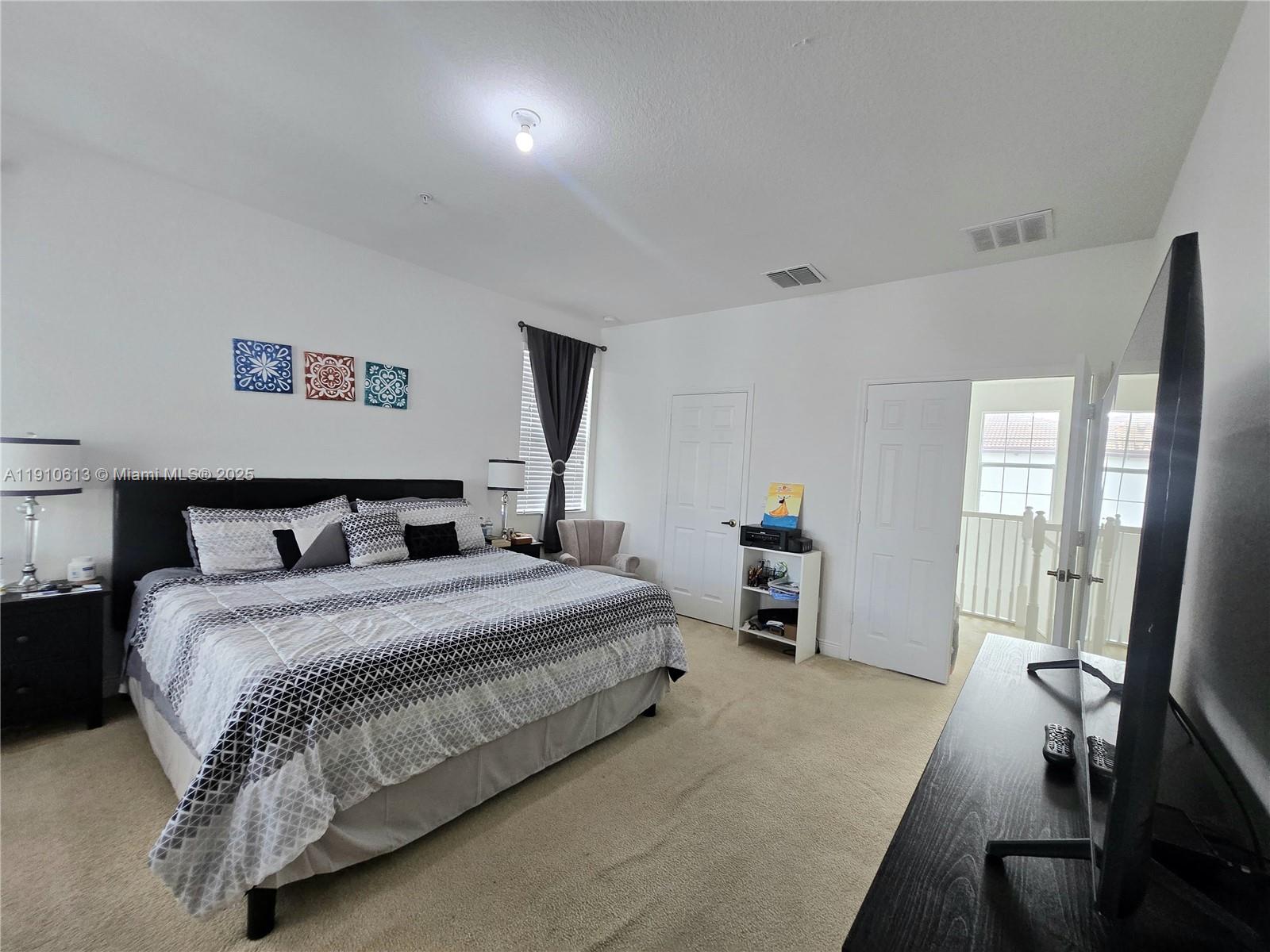 11938 Southwest 26th Court Miramar, FL 33025 - Photo 37 of 62 a bedroom with a bed and a large window