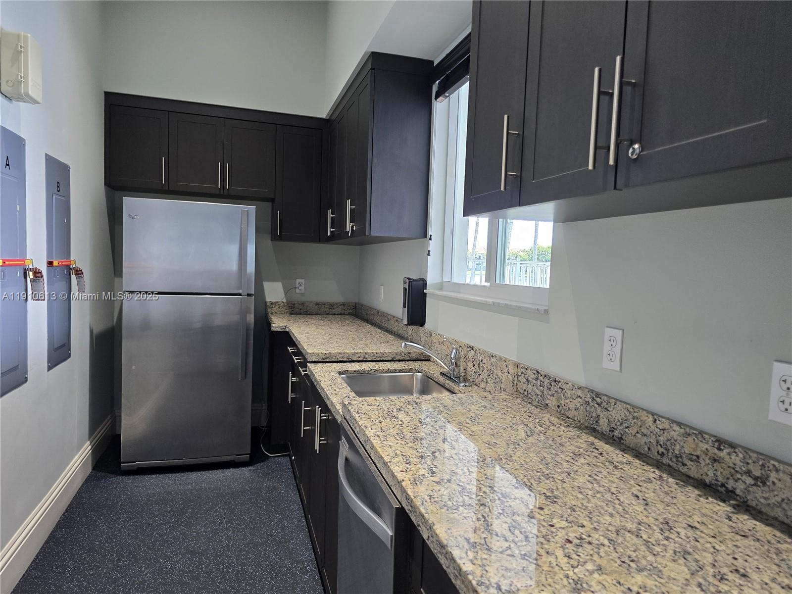 11938 Southwest 26th Court Miramar, FL 33025 - Photo 59 of 62 a kitchen with stainless steel appliances granite countertop a sink stove and refrigerator