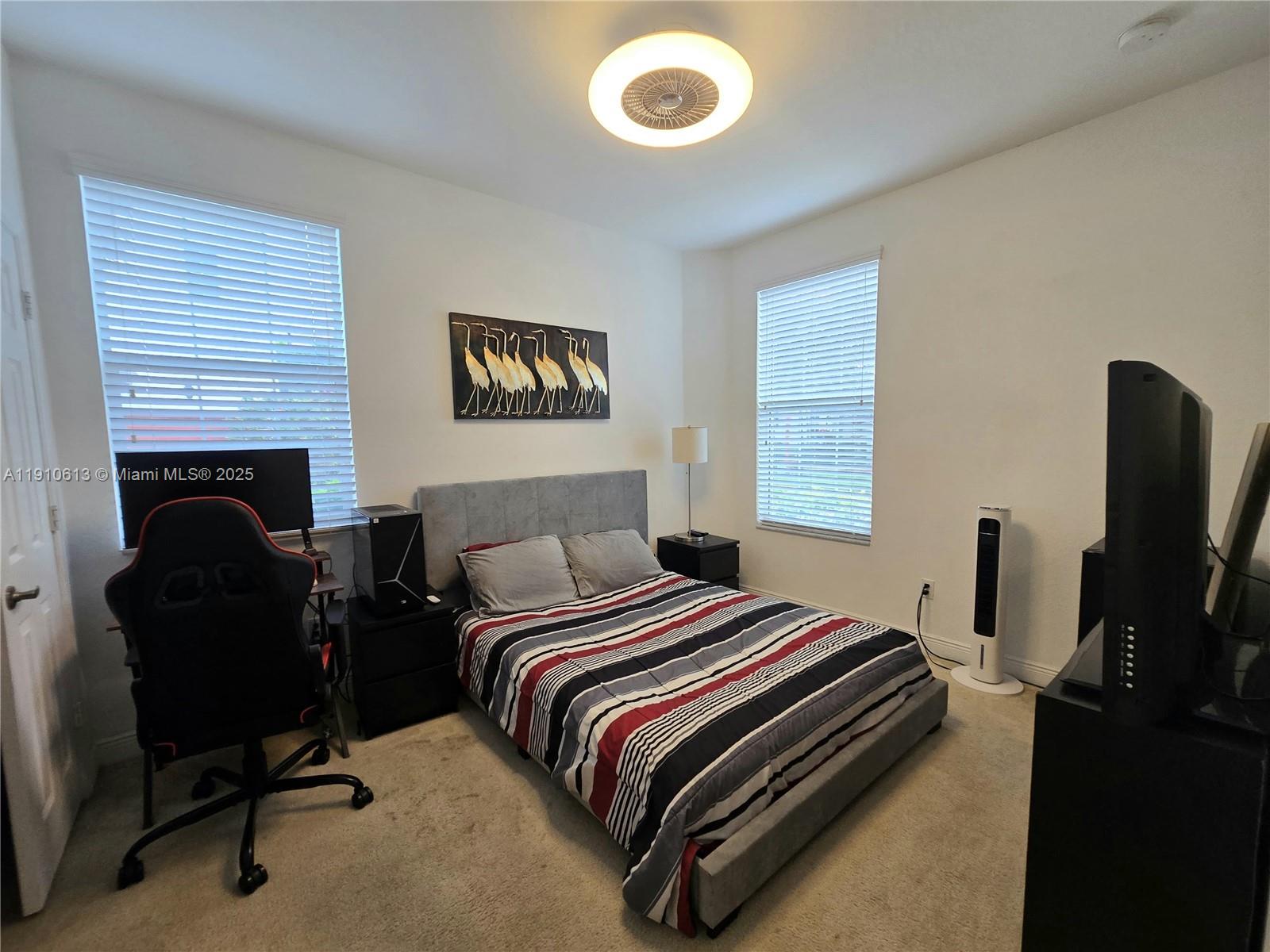 11938 Southwest 26th Court Miramar, FL 33025 - Photo 8 of 62 a bedroom with a bed and a flat screen tv