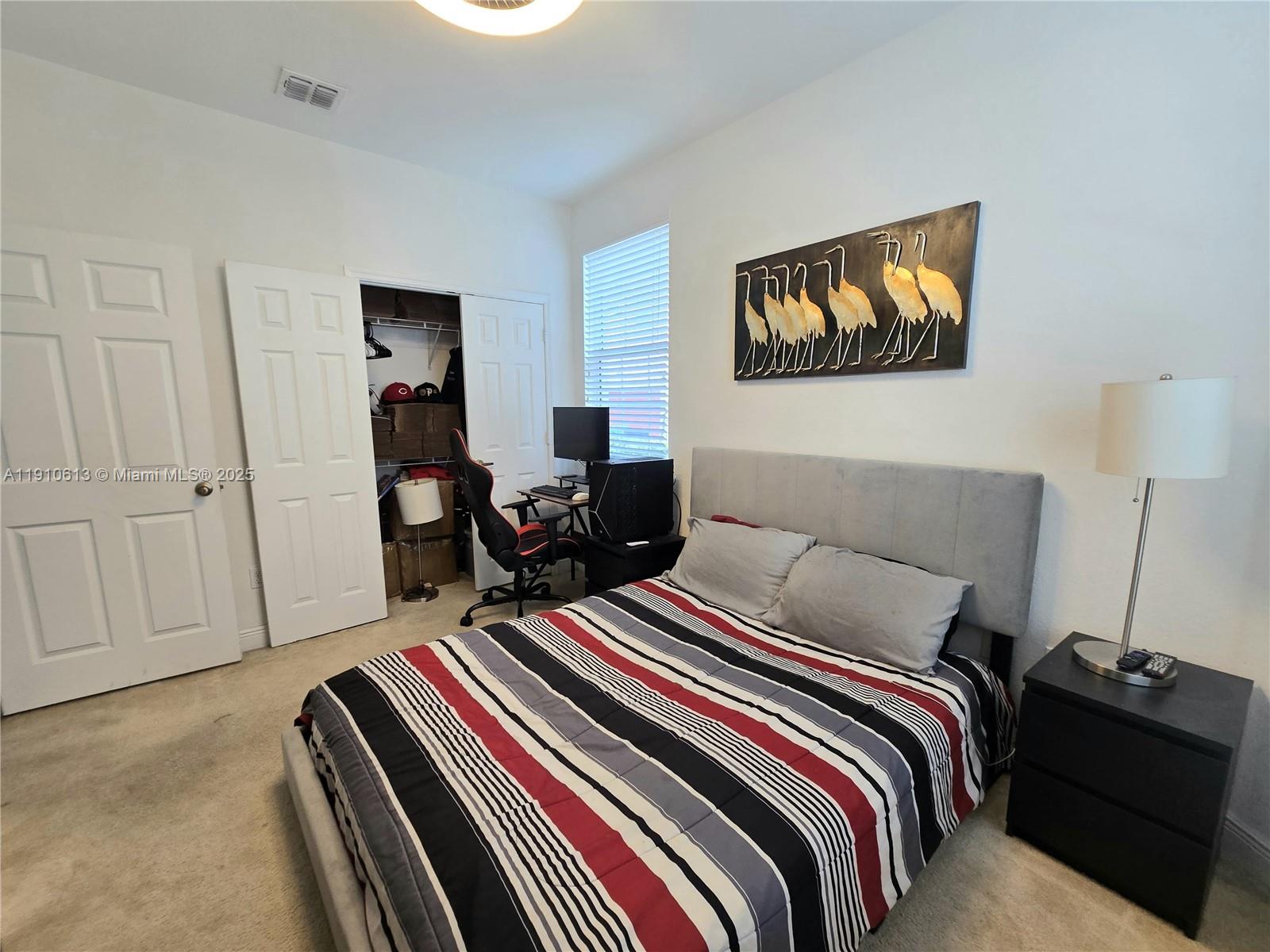 11938 Southwest 26th Court Miramar, FL 33025 - Photo 9 of 62 a bedroom with a bed and wooden floor