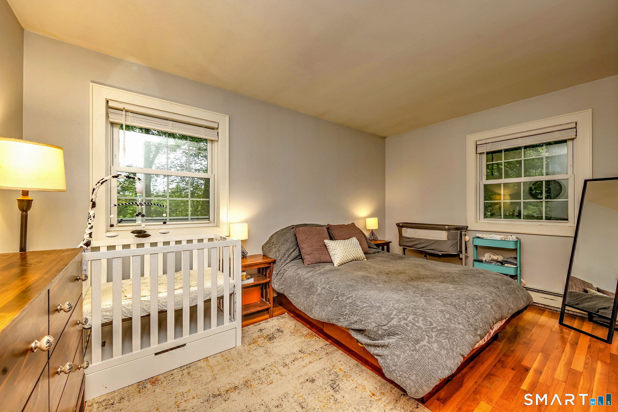 265 Shelter Rock Road Fairfield, CT 06825 - Photo 14 of 32 Spacious primary bedroom with hardwood flooring.