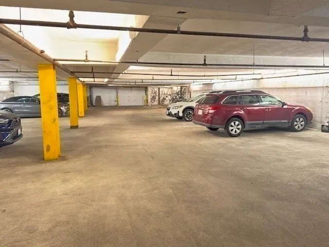 a view of parking garage with cars