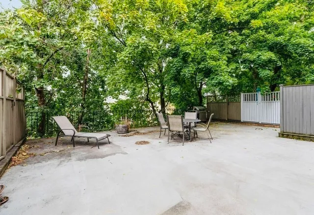 a view of a backyard with a table and chairs