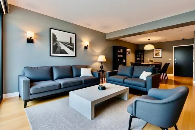 a living room with furniture and kitchen view