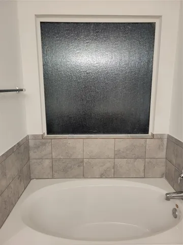 a bathroom with a glass shower door