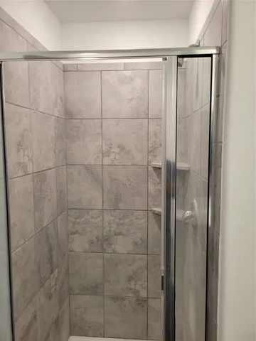 a white toilet sitting next to a white wall