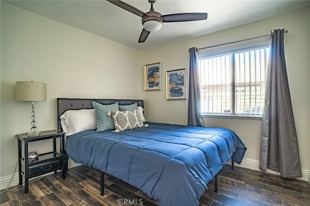 a bedroom with a bed and wooden floor