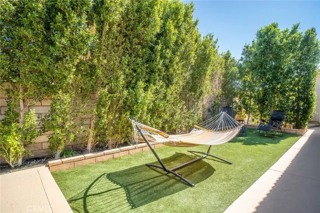 a lawn chair and table with wooden fence