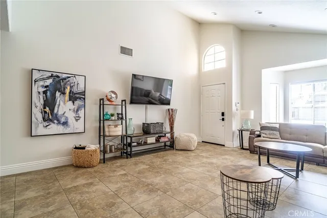 a living room with furniture a air conditioner vent and a window