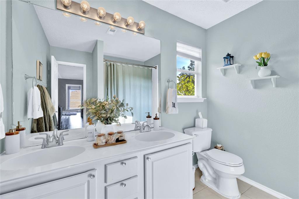 2409 Loon Lake Road Denton, TX 76210 - Photo 20 of 30 Upstairs full bath with dual sinks.