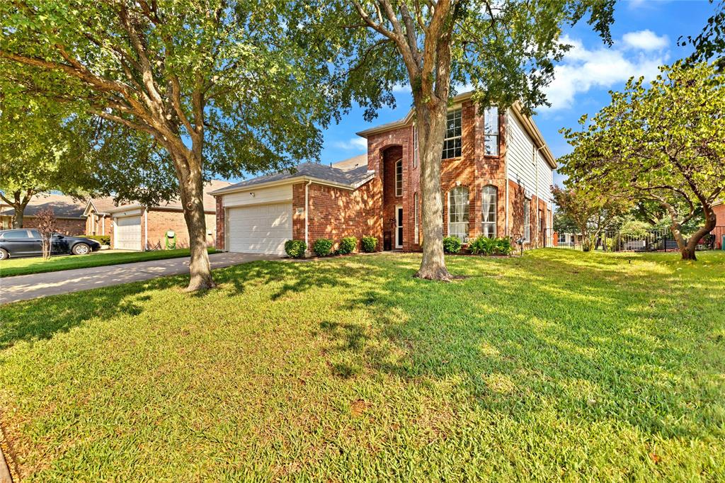 2409 Loon Lake Road Denton, TX 76210 - Photo 2 of 30 This charming property boasts a beautifully treed lot, offering a serene and natural setting.