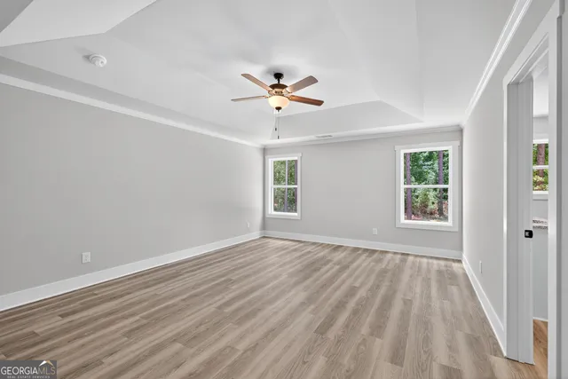 wooden floor in an empty room with a window