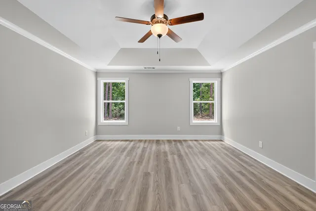 a view of a livingroom with a ceiling fan and window