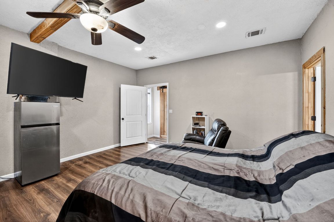 174 Monroe Lane Elgin, TX 78621 - Photo 12 of 21 a bedroom with a bed and a flat screen tv