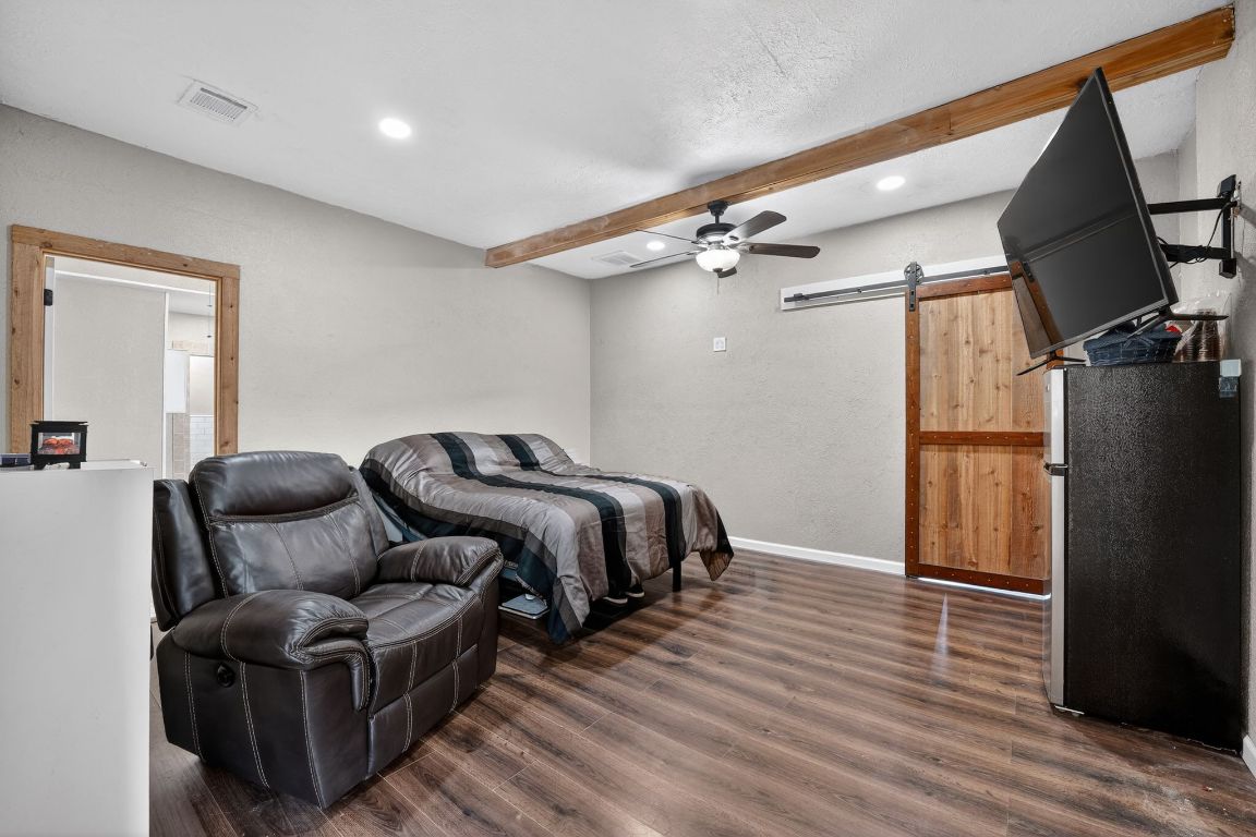 174 Monroe Lane Elgin, TX 78621 - Photo 13 of 21 a bedroom with bed and wooden floor