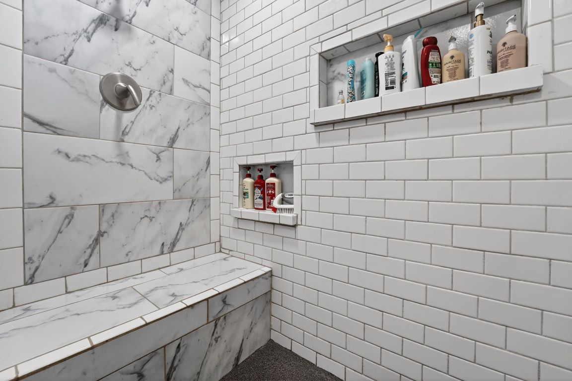 174 Monroe Lane Elgin, TX 78621 - Photo 15 of 21 a bathroom with a granite countertop sink and a shower