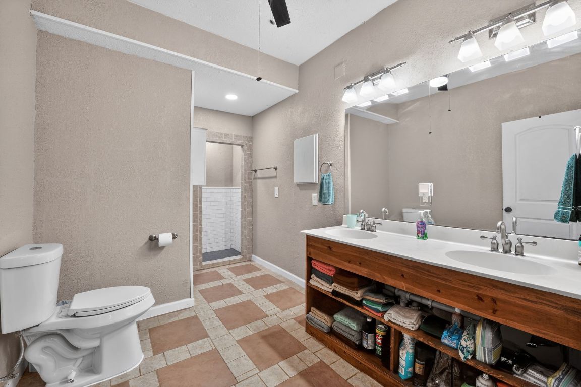 174 Monroe Lane Elgin, TX 78621 - Photo 16 of 21 a spacious bathroom with a double vanity sink toilet and a mirror