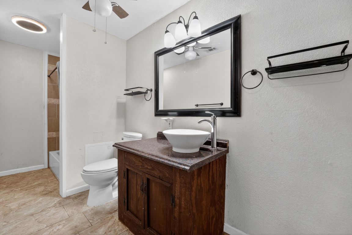 174 Monroe Lane Elgin, TX 78621 - Photo 17 of 21 a bathroom with a sink toilet and mirror
