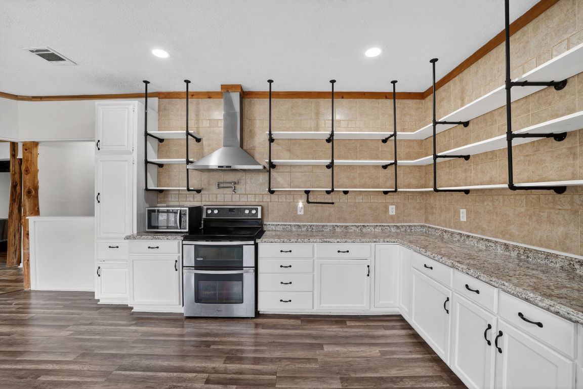 174 Monroe Lane Elgin, TX 78621 - Photo 10 of 21 a kitchen with stainless steel appliances granite countertop a stove and a sink