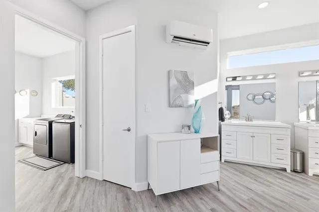 a bathroom with a toilet a sink and mirror